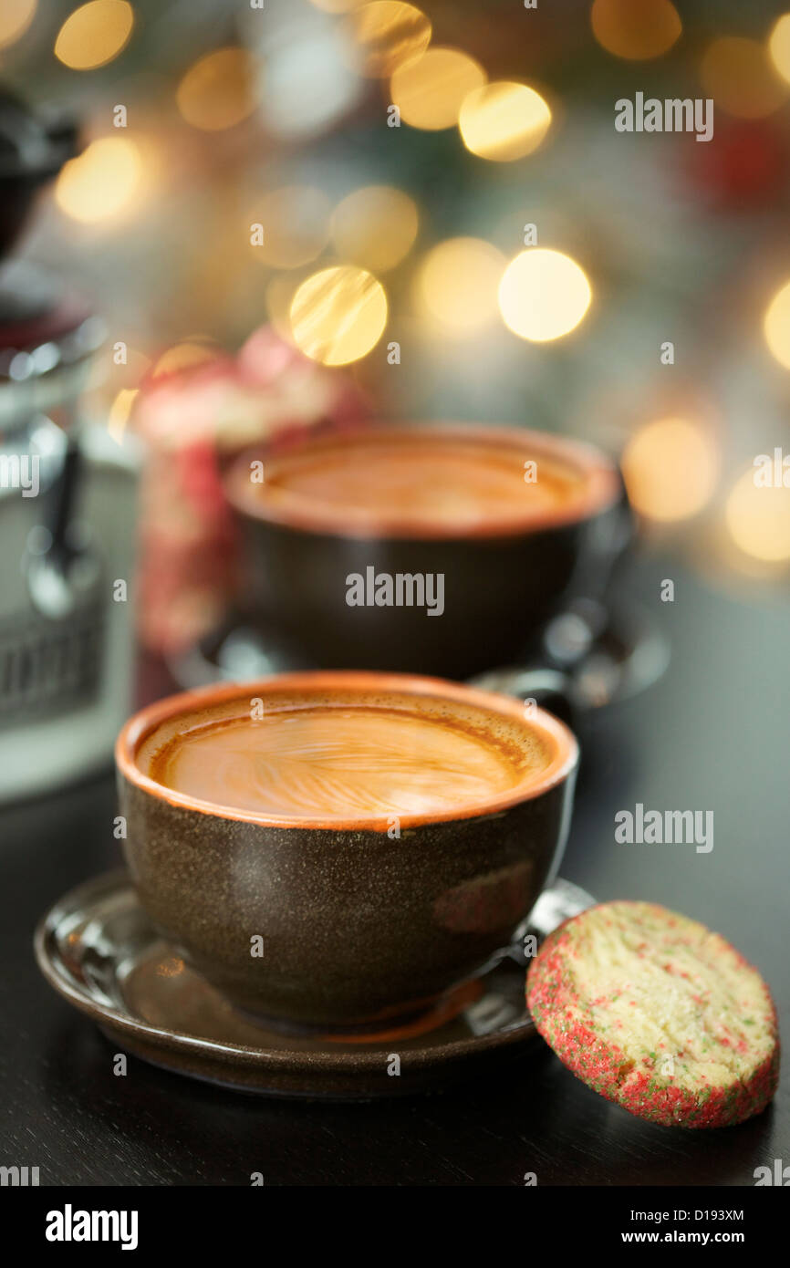 Cappuccino with beautiful latte art and Christmas light bokeh in the background Stock Photo