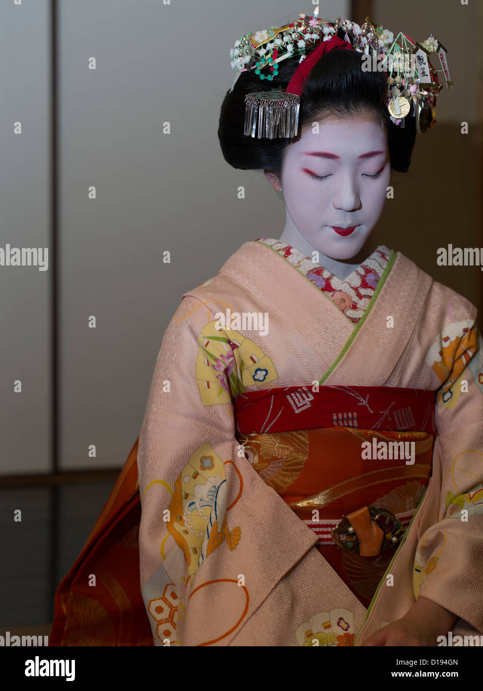 Eriha at 17 year old maiko ( trainee geisha ) entertaining guests in a Gion teahouse in Kyoto, Japan Stock Photo