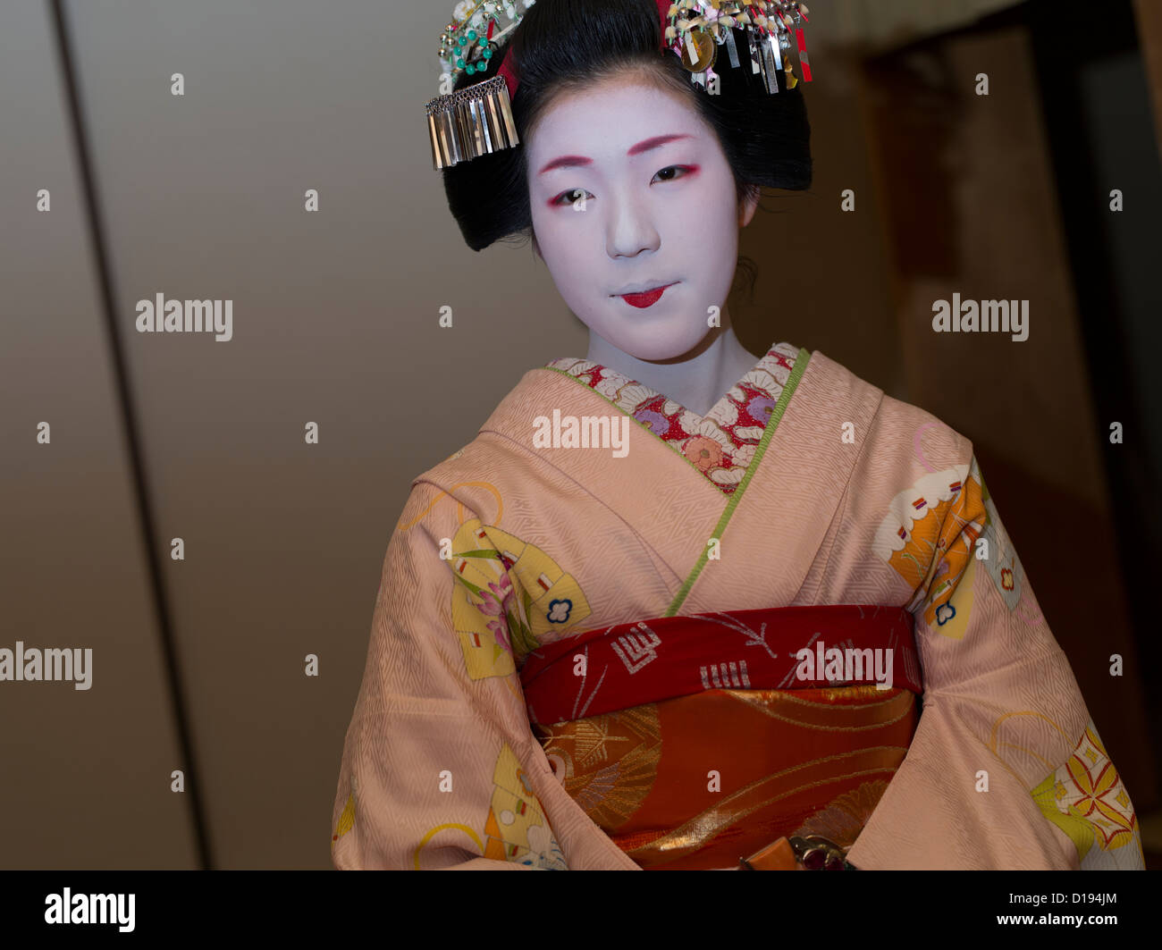Eriha at 17 year old maiko ( trainee geisha ) entertaining guests in a Gion teahouse in Kyoto, Japan Stock Photo