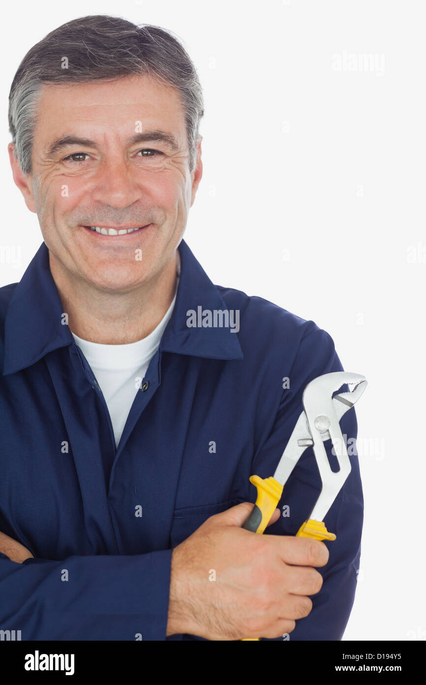 Mechanic with arms crossed holding pliers Stock Photo Alamy