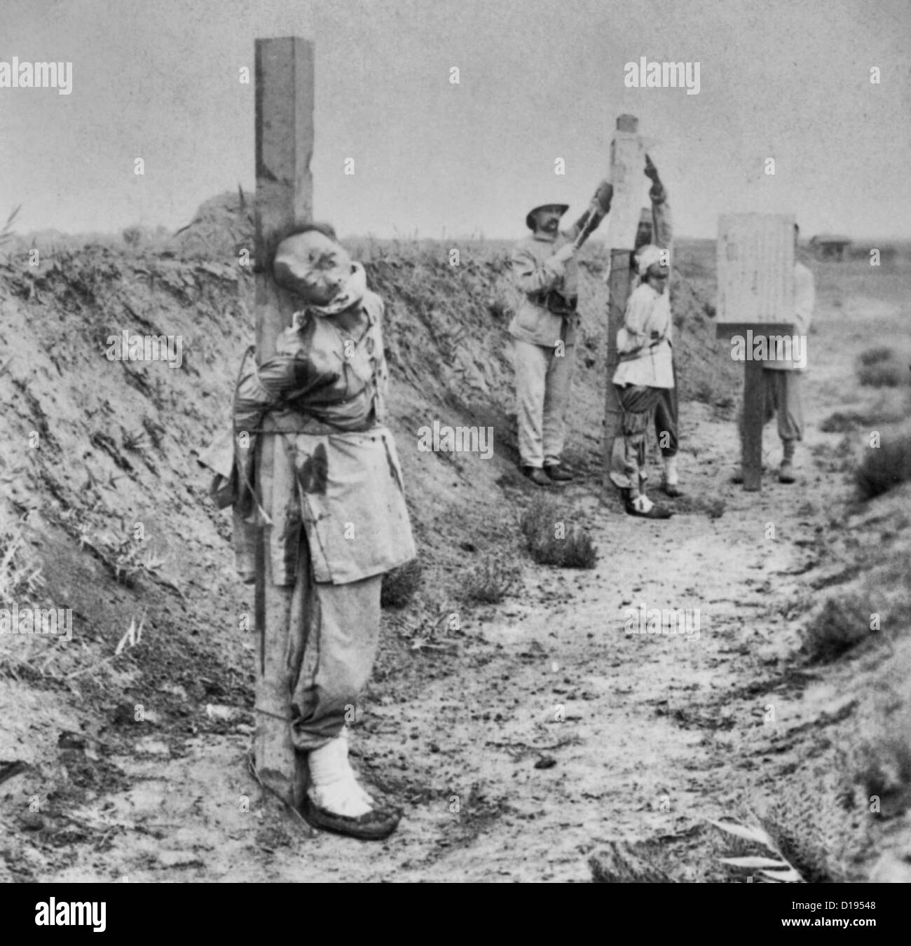Allies stern government at Tientsin - Chinese criminals immediately after being shot - soldiers posting execution proclamation - China, 1901 Stock Photo