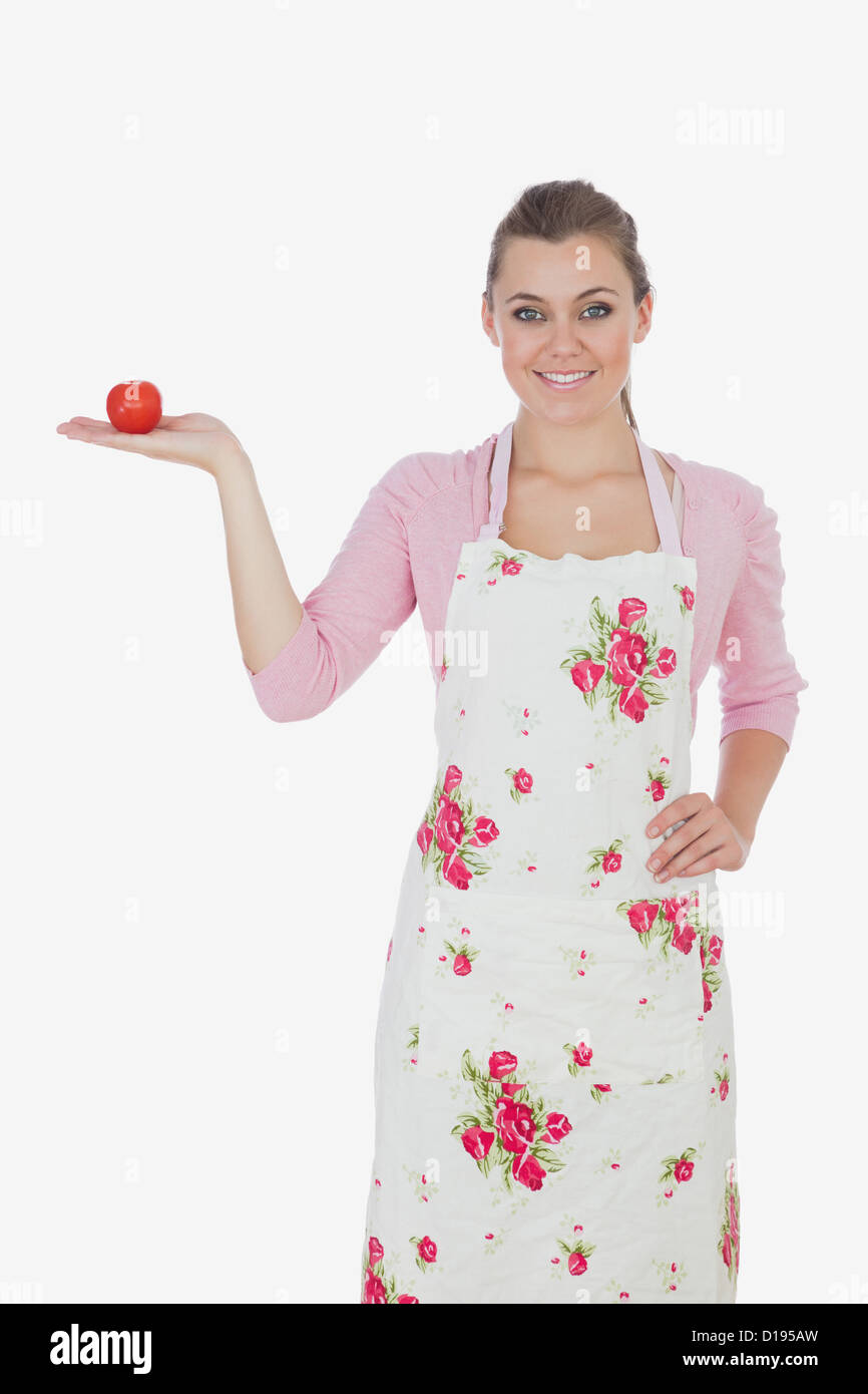 Young woman holding tomato Stock Photo - Alamy