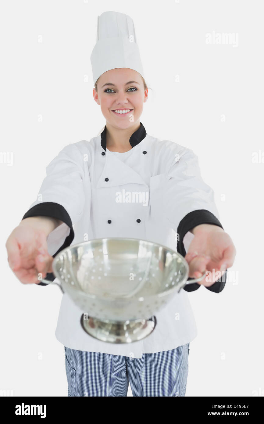 Colander Chef Female chef offering colander Stock Photo - Alamy