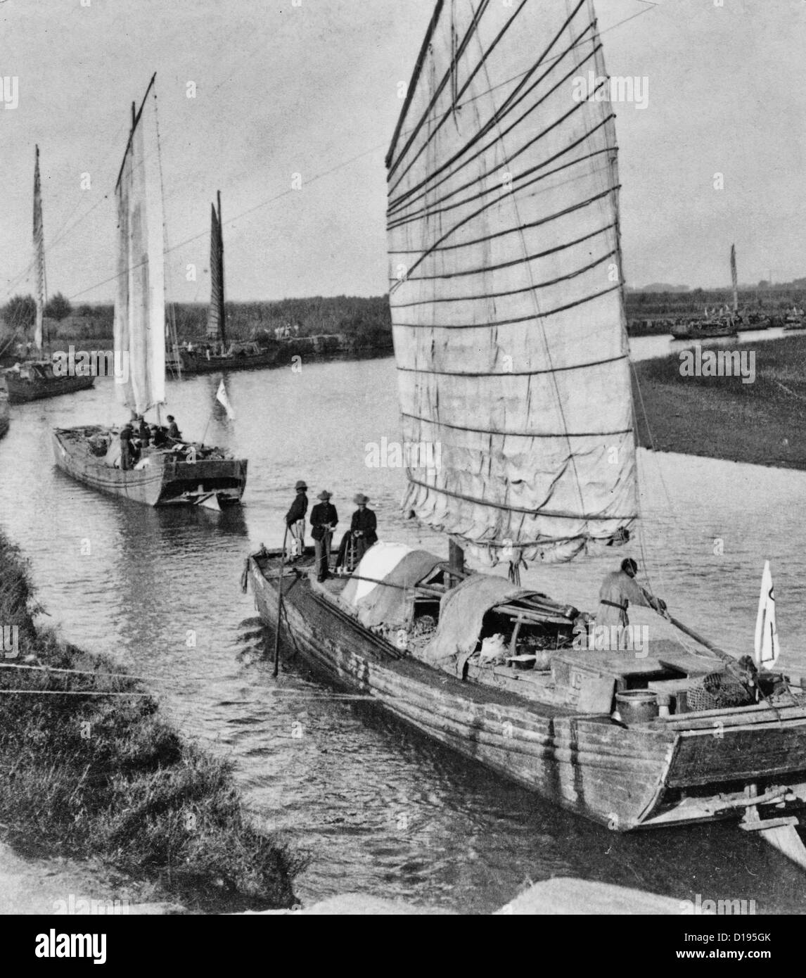 Junk flotilla on the Peiho River - transporting U.S. Army stores from Tientsin to Peking, China during Boxer Rebellion, circa 1900 Stock Photo