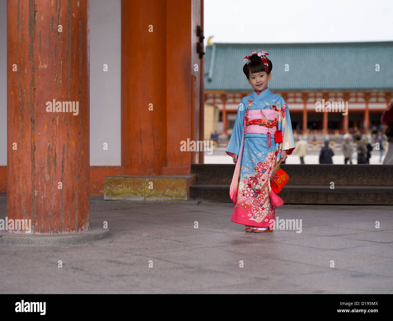 Young Japanese girl in kimono and obi visits a shrine in Kyoto Japan. Children aged 7, 5 and 3 visit shrines on their birthday. Stock Photo