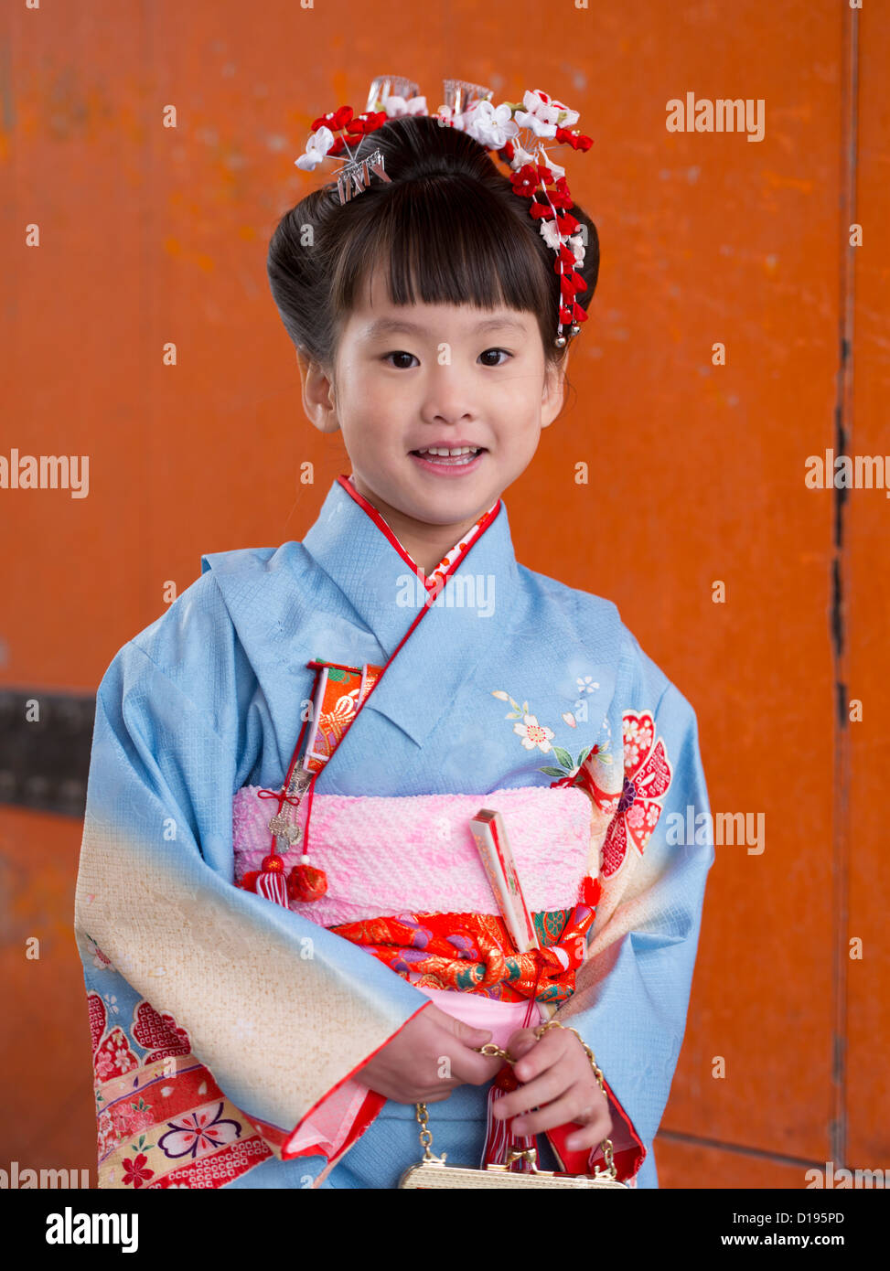 Young Japanese girl in kimono and obi visits a shrine in Kyoto Japan. Children aged 7, 5 and 3 visit shrines on their birthday. Stock Photo