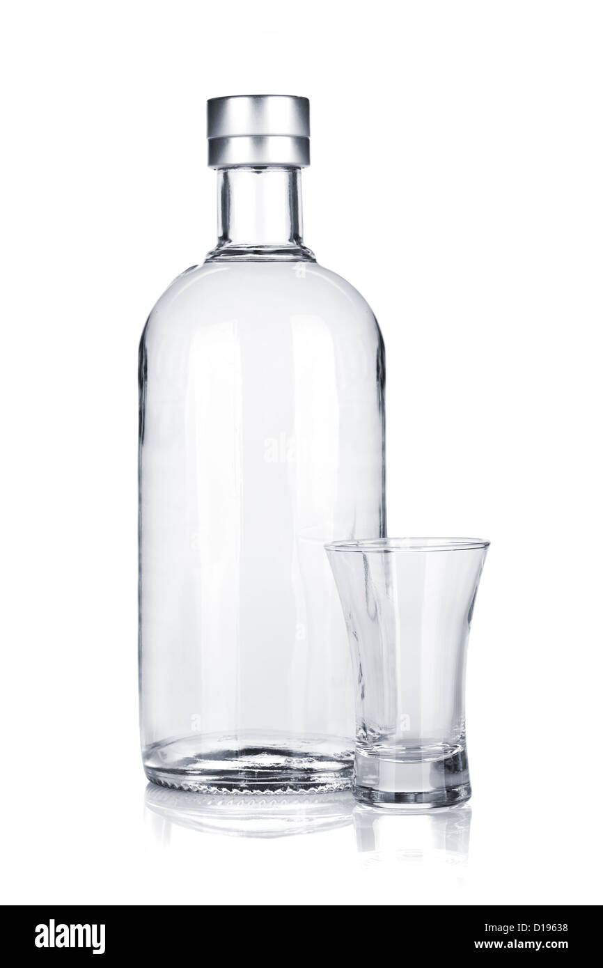 Bottle of vodka and empty shot glass. Isolated on white background