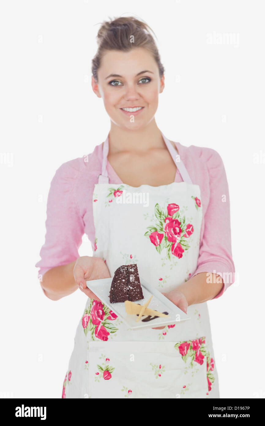 Young woman holding plate of tempting pastry Stock Photo