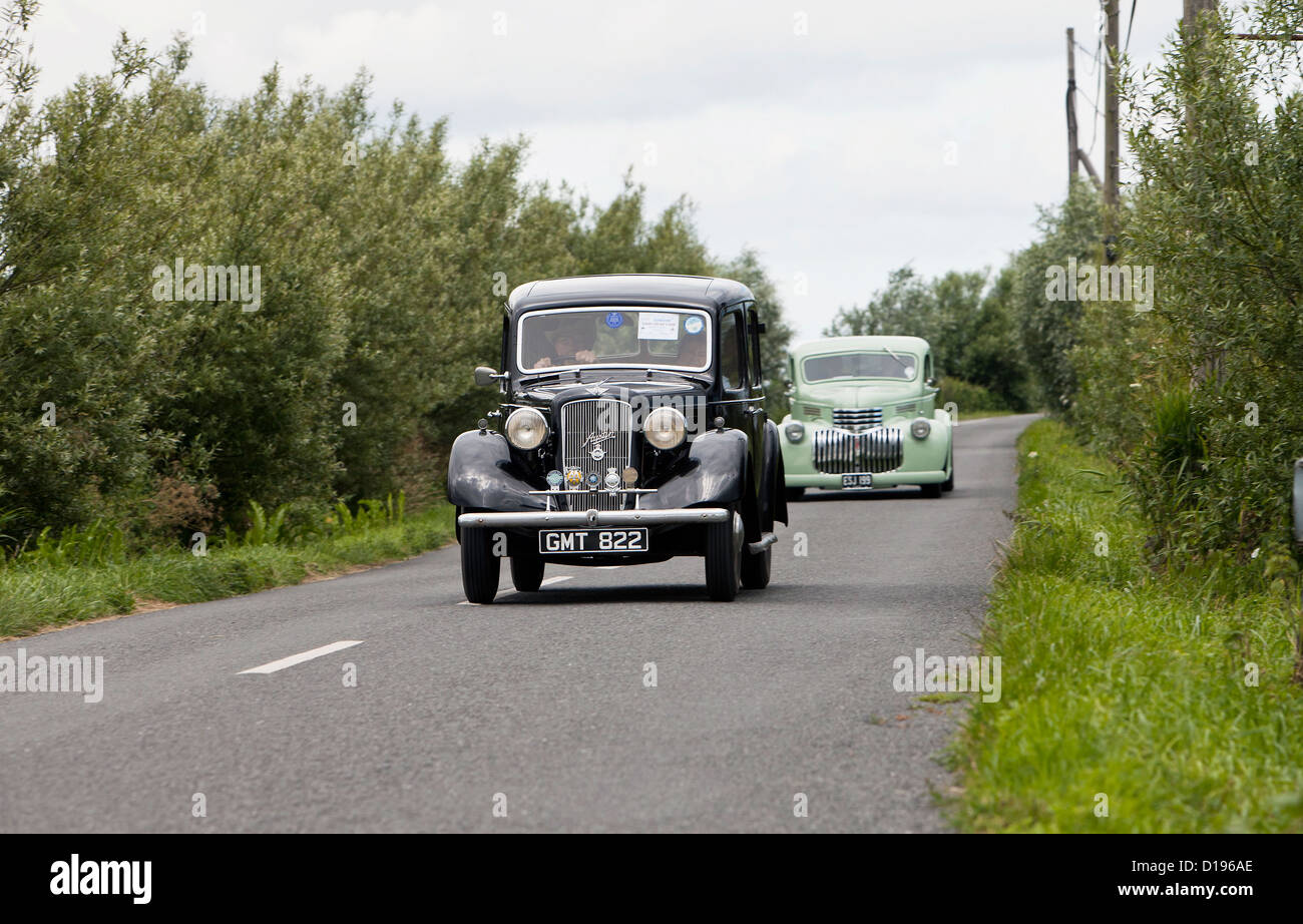 Classic Austin 10 followed by Chevrolet Pick-up, both en route to Centre 81 Classic Car Show in Great Yarmouth Stock Photo