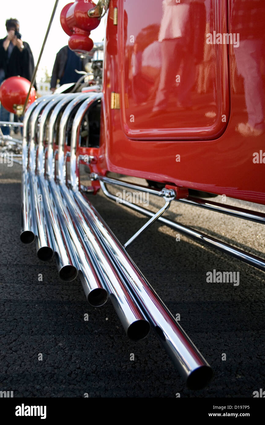 6 Silver exhausts running along the side of drag racing hot rod Stock