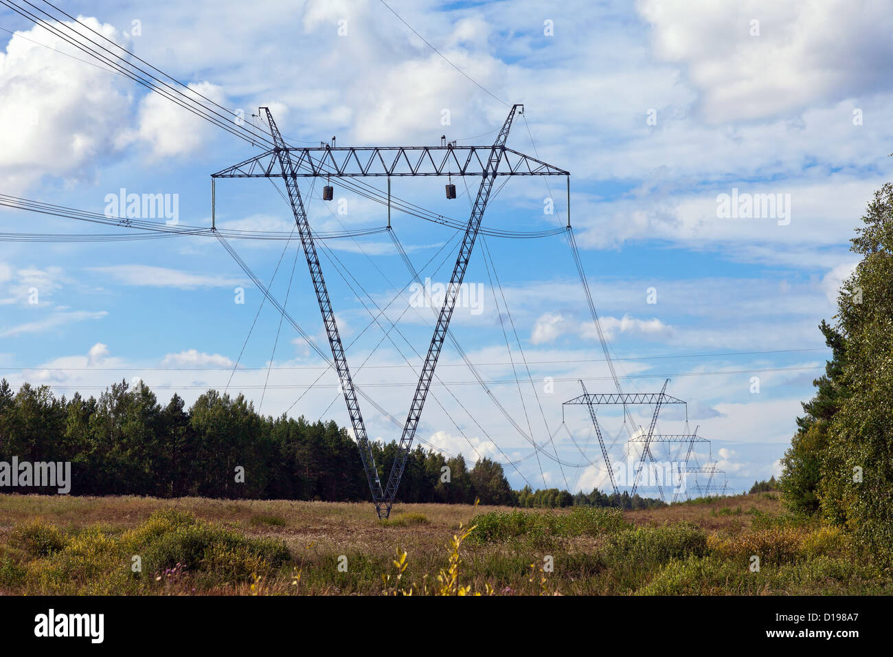 Electricity pylon on a background of blue sky with clouds Stock Photo ...