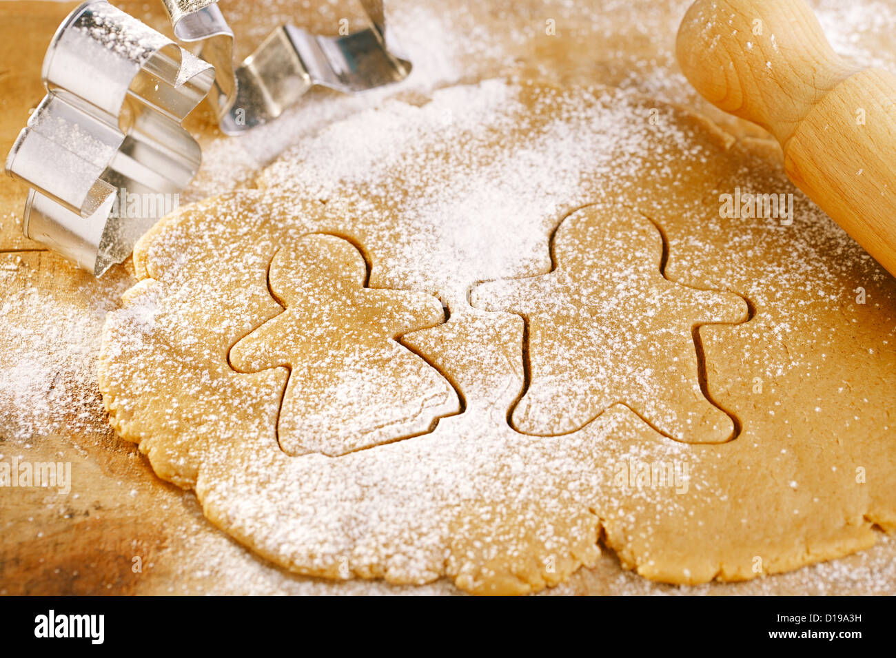 gingerbread boy and girl cookies cutters on rolling dough, shallow dof