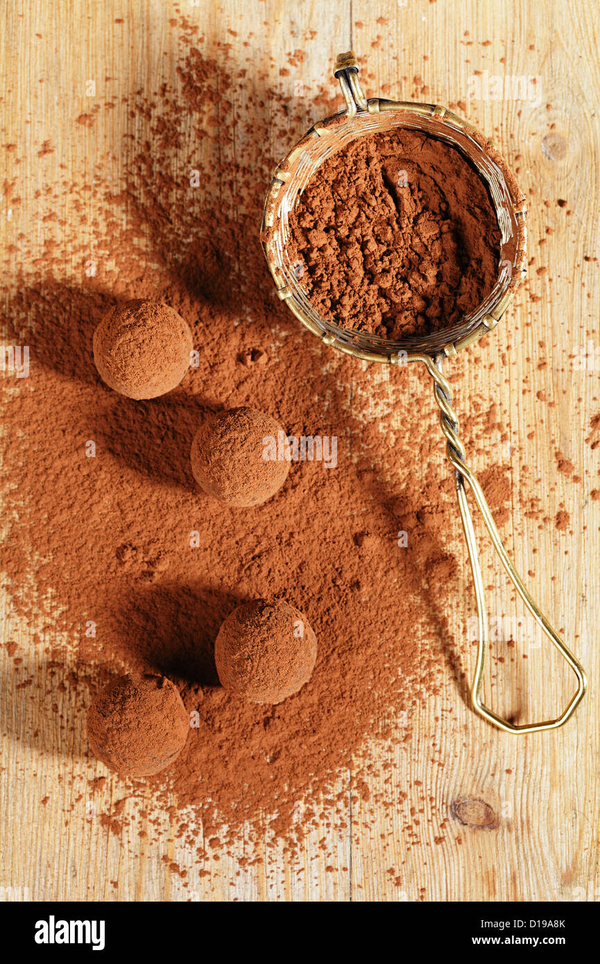chocolate truffles cocoa powder dusted and sieve, shallow dof Stock Photo Alamy