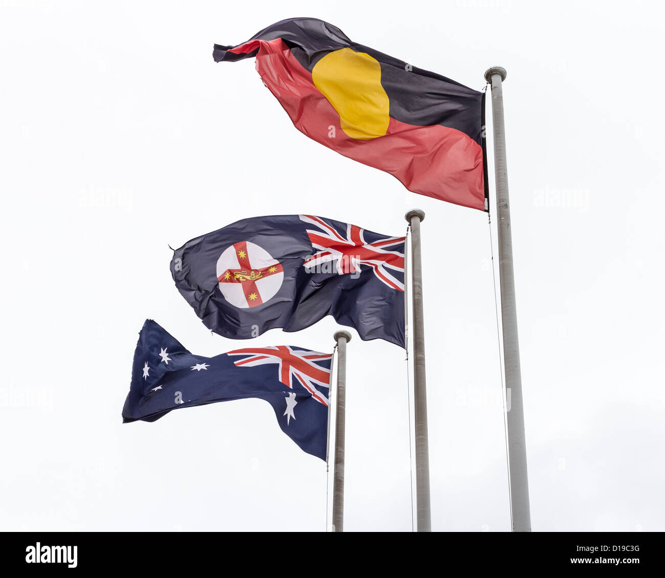 The Australian, the New South Wales and the Aboriginal flags flying together Stock Photo
