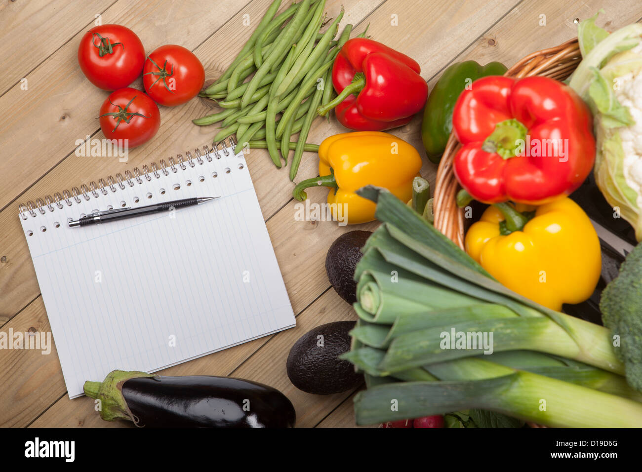 Book with pen and vegetables Stock Photo