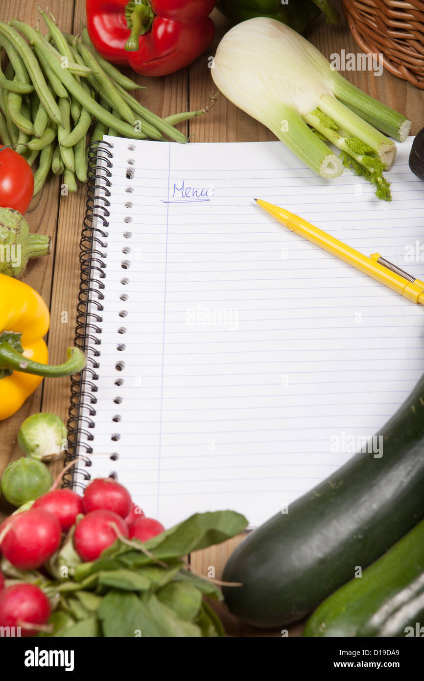 Book surrounded with variety of vegetables Stock Photo