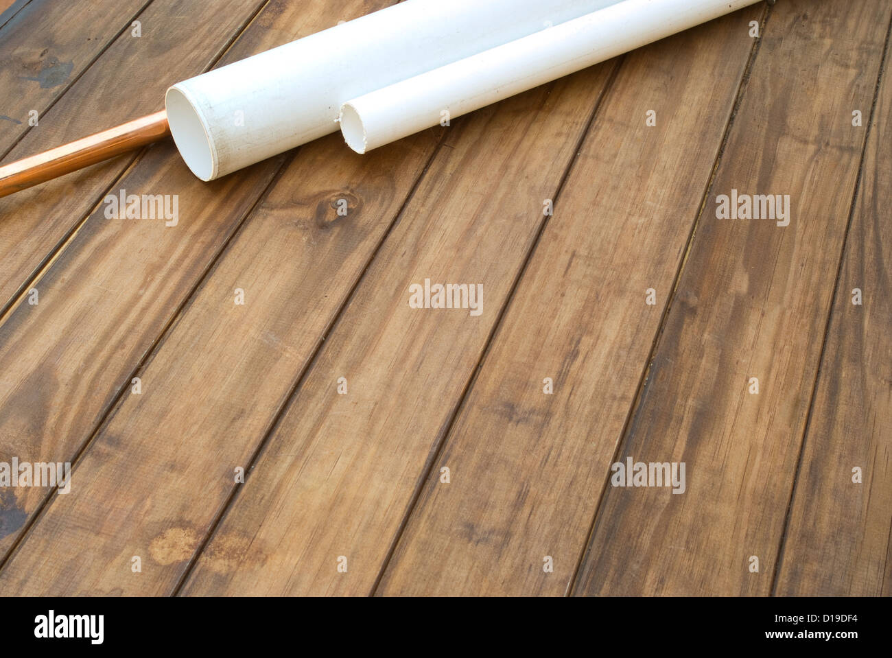 Plumbers plumbing pipes on wooden work table Stock Photo