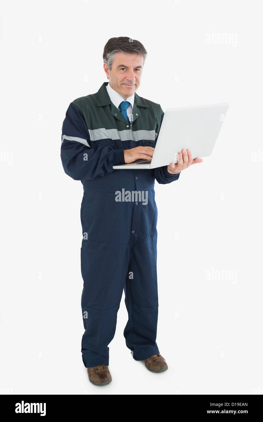 Mature repairman with laptop Stock Photo