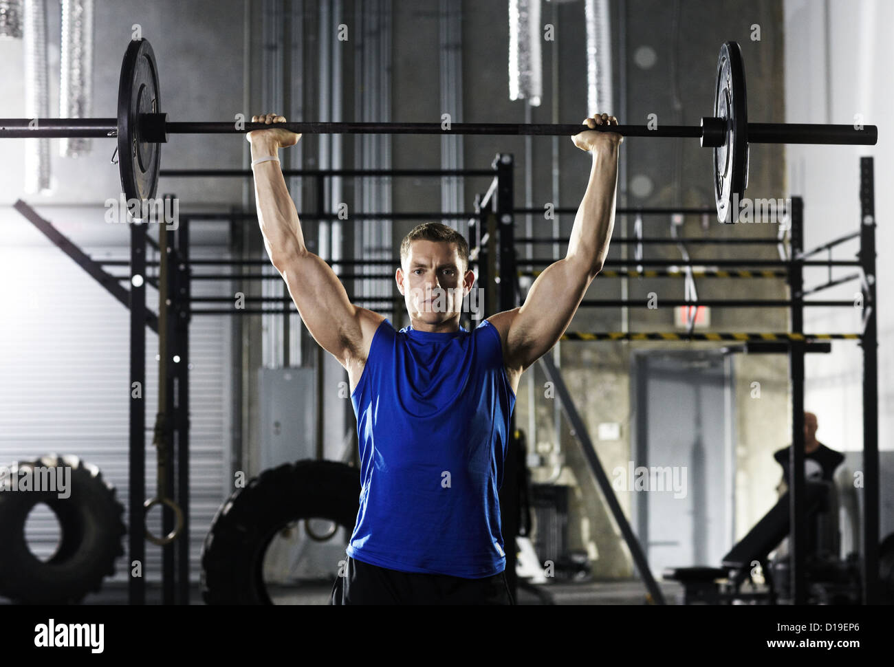 Man lifting barbell above his head Stock Photo Alamy