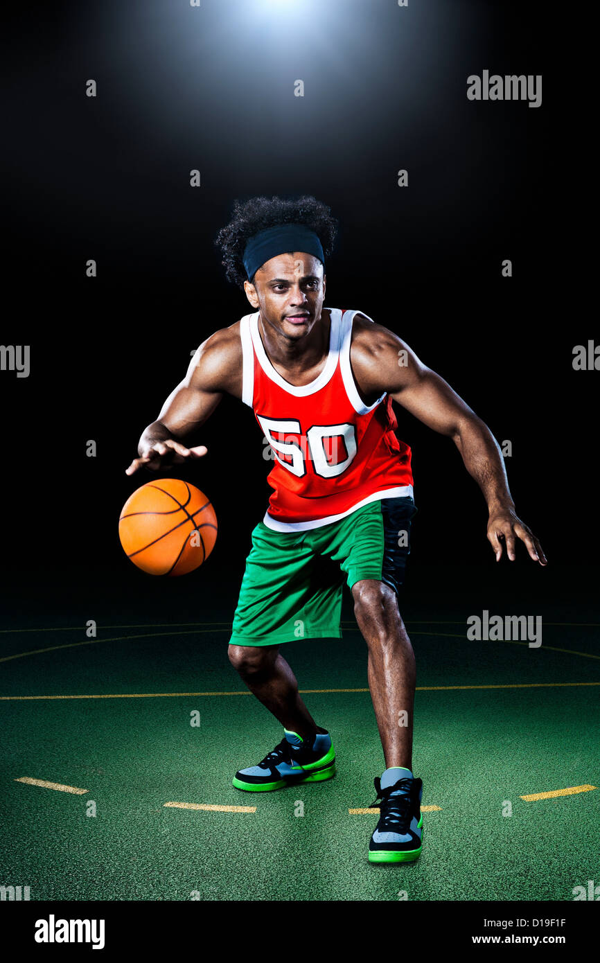 Basketball player bouncing ball Stock Photo Alamy