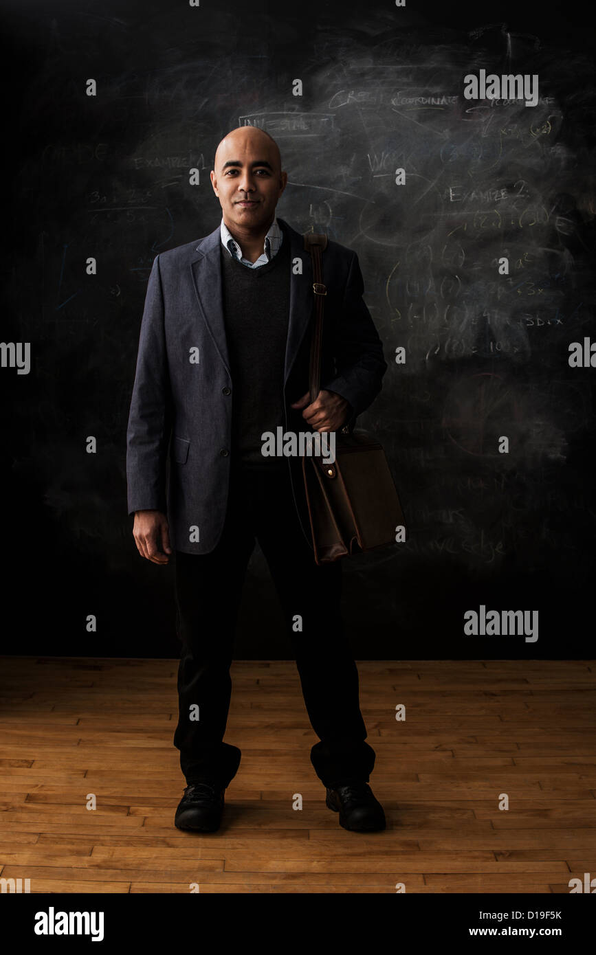 Businessman by blackboard with stachel Stock Photo