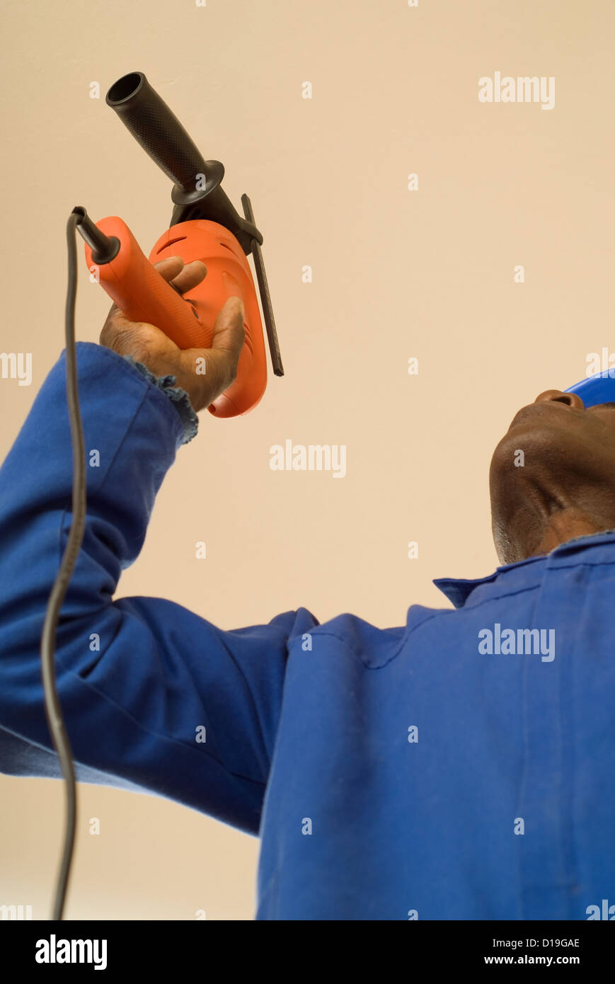 African American Construction Worker Handyman Carpenter Drilling With Electrical Power Tool