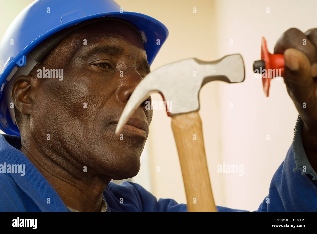 African American Construction Worker with Hammer in Hand Stock Photo