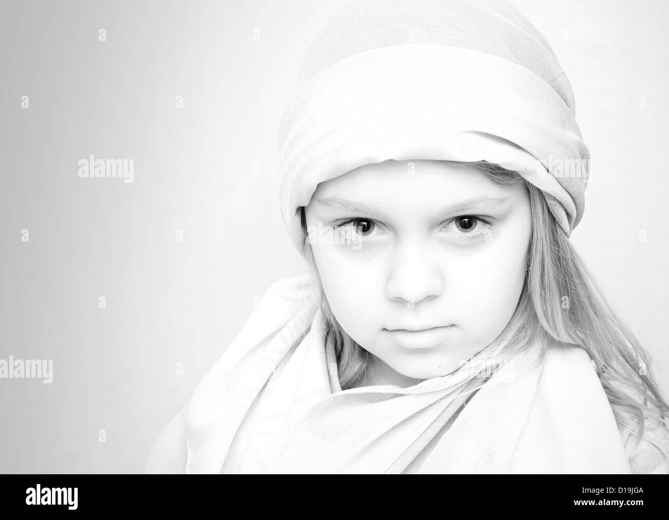 Closeup monochrome portrait of little blond girl in white Stock Photo