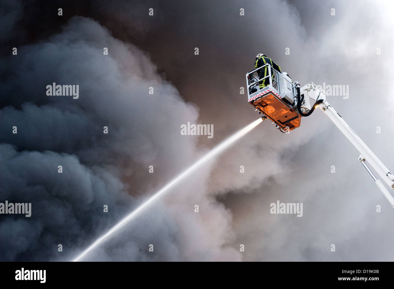 A fire fighter at work in a hydraulic hoist Stock Photo
