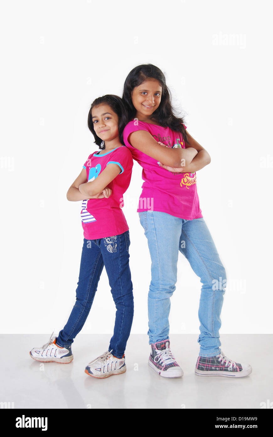 Young girls posing as models in casual dress and jeans Stock Photo - Alamy