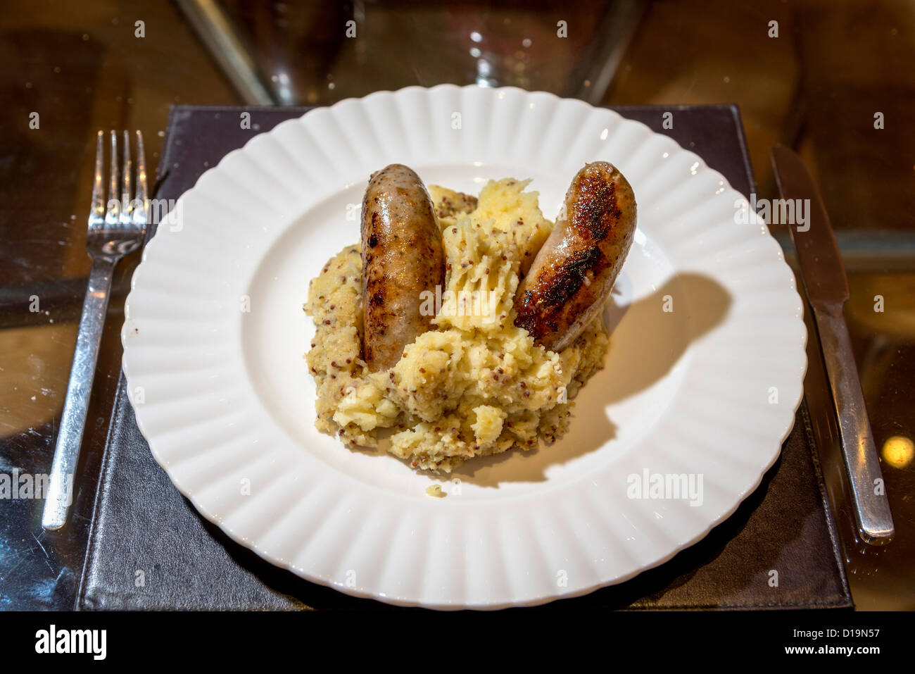 A plate of sausage and mustard mash. sausages mashed potato Stock Photo