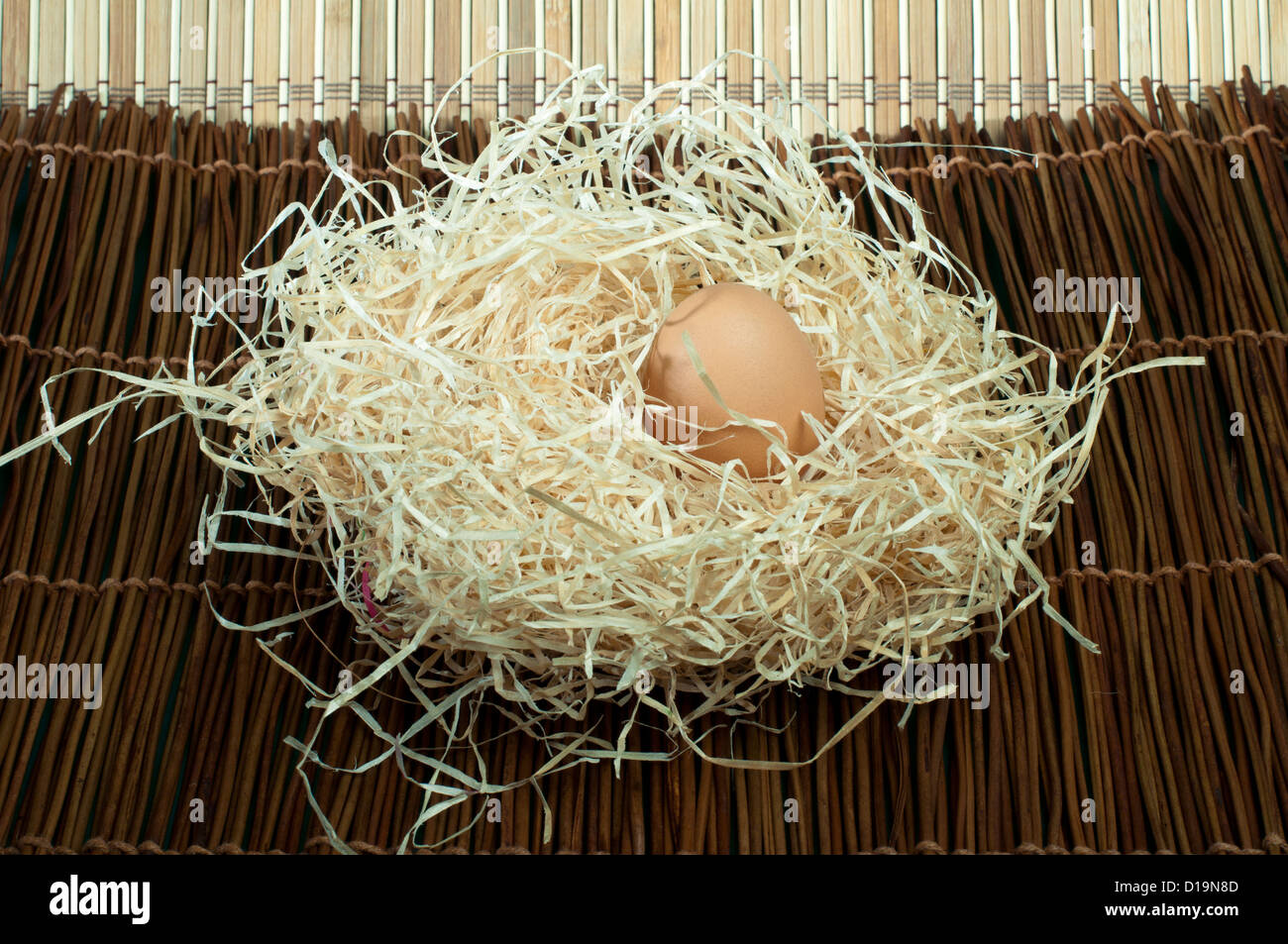 Three raw eggs in straw Stock Photo Alamy