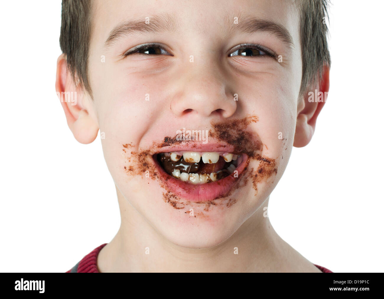 Smiling kid eating chocolate. Smeared stained with chocolate lips