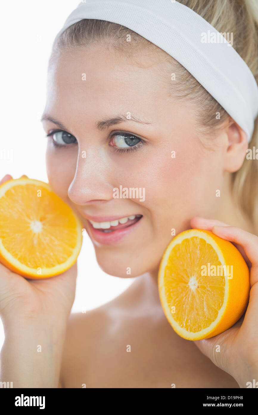 Beautiful woman holding orange slices Stock Photo - Alamy
