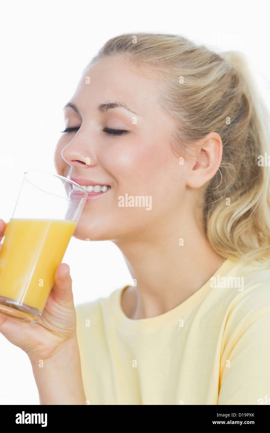 Woman drinking orange juice Stock Photo Alamy
