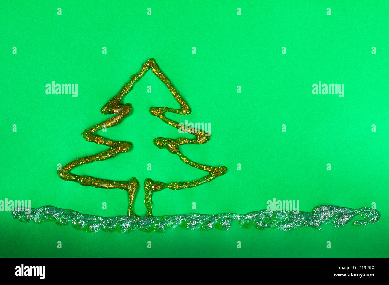 Christmas tree made of shiny gel over green paper Stock Photo