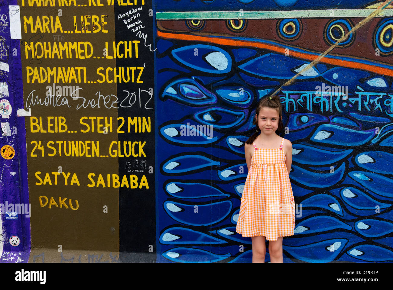 LITTLE GIRL BY THE BERLIN WALL Stock Photo