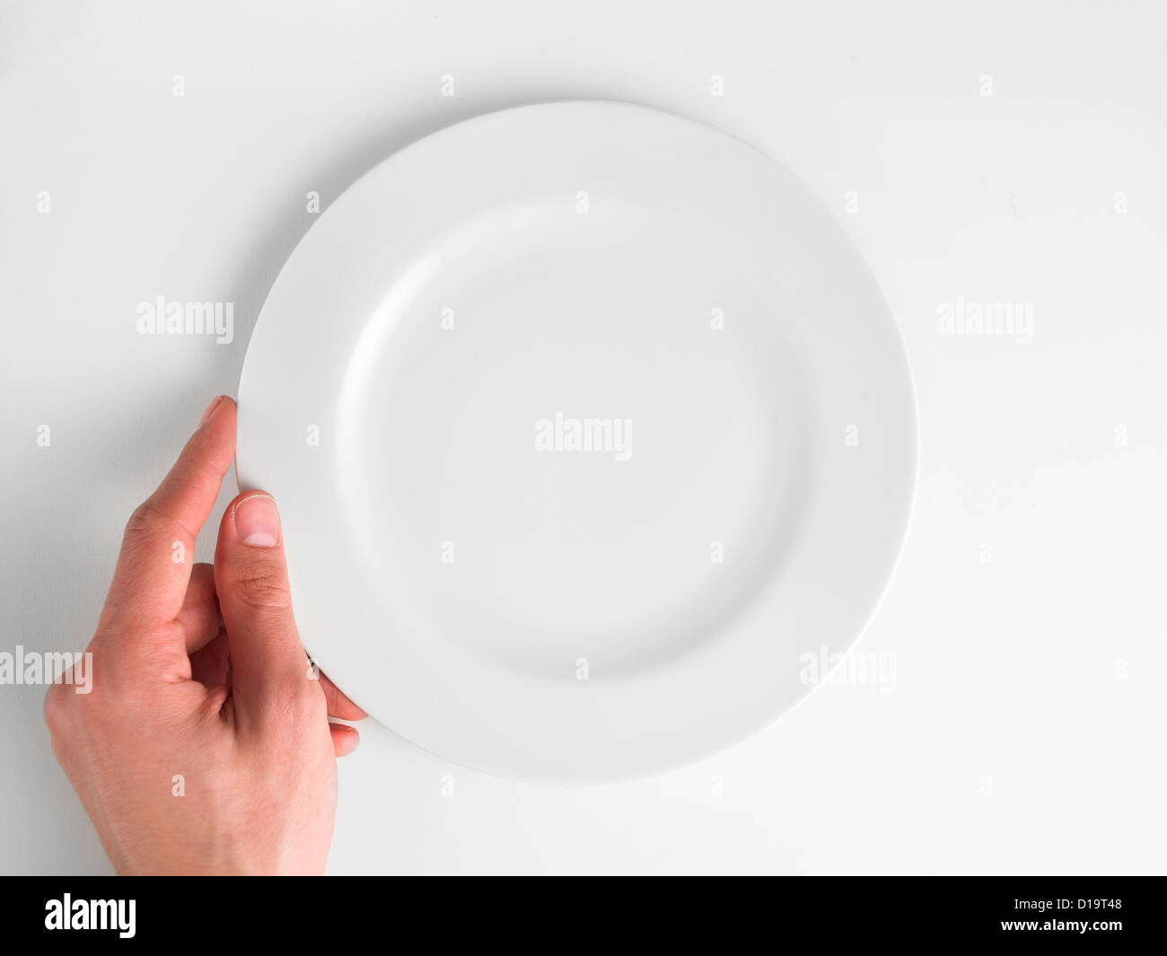 Empty plate with hand Stock Photo