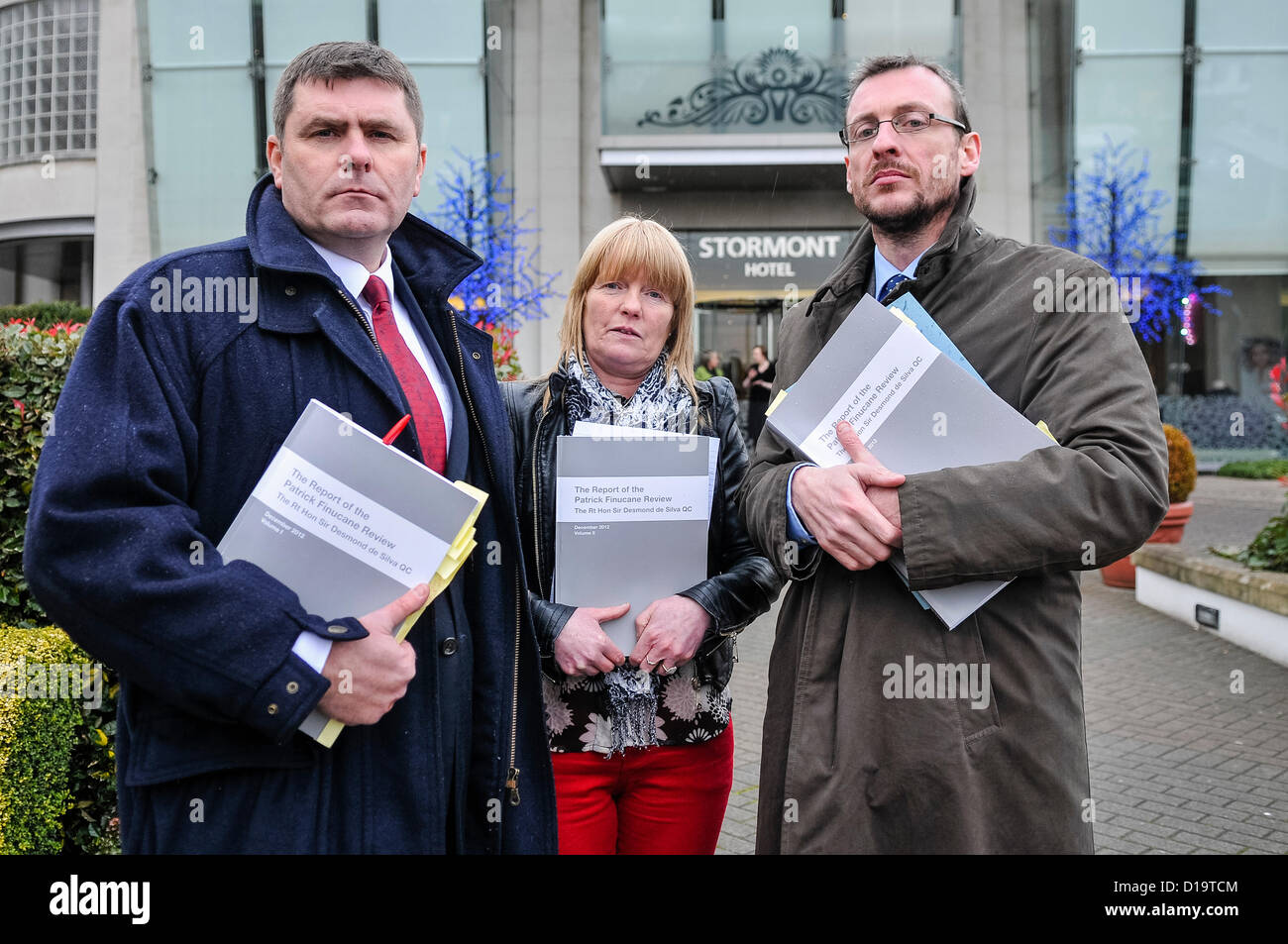 12th December 2012 - Belfast, Northern Ireland. Mark Thompson (Relatives for Justice), Theresa Sloan (widow of Gerard Sloan) and Paul Pierce (Kevin R. Winters & Co) receive their copies of the report by The Rt Hon sir Desmond de Silva into the death of Belfast solicitor Patrick (Pat) Finucane. Credit:  Stephen Barnes / Alamy Live News Stock Photo