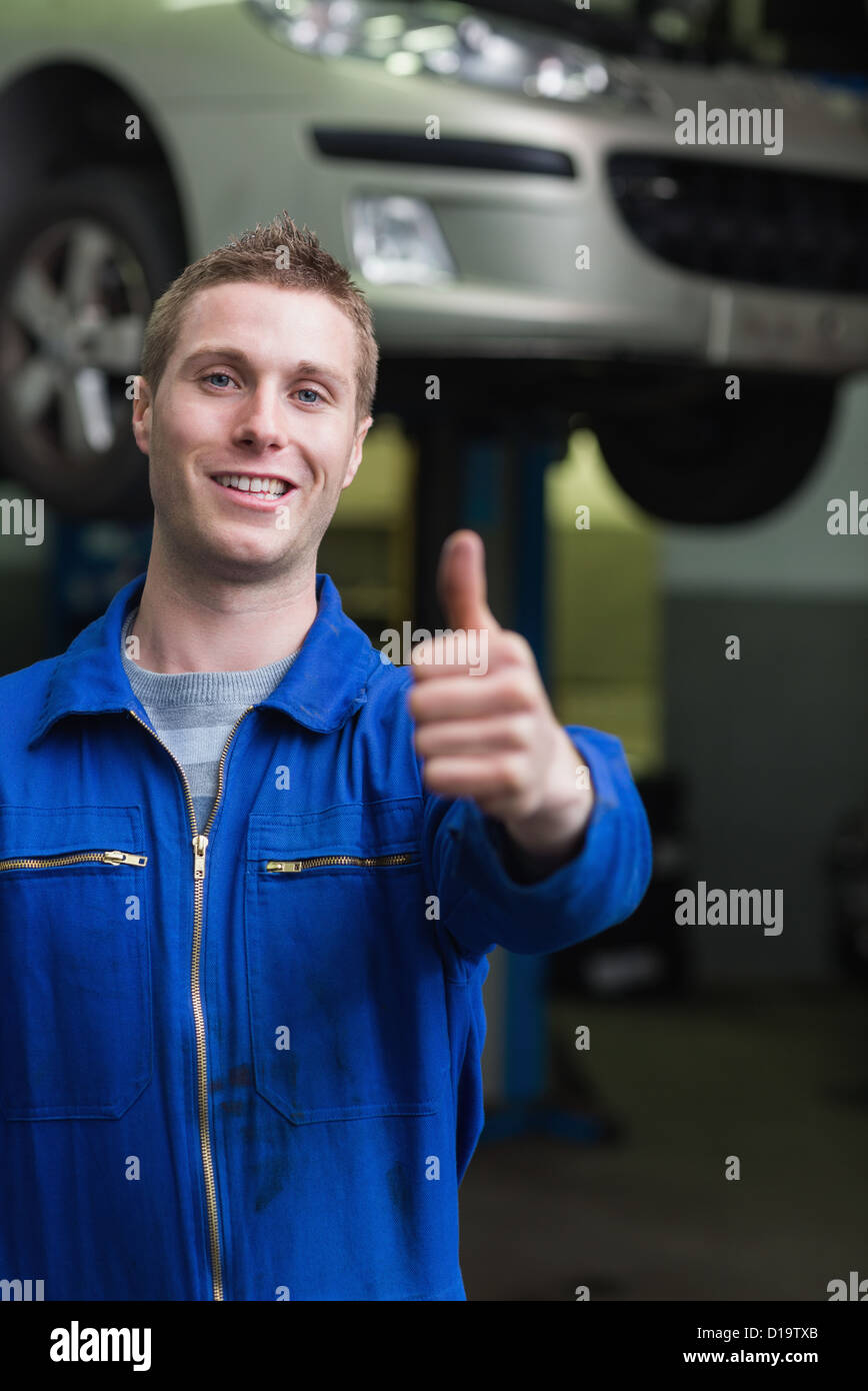 Happy car mechanic gesturing thumbs up Stock Photo Alamy