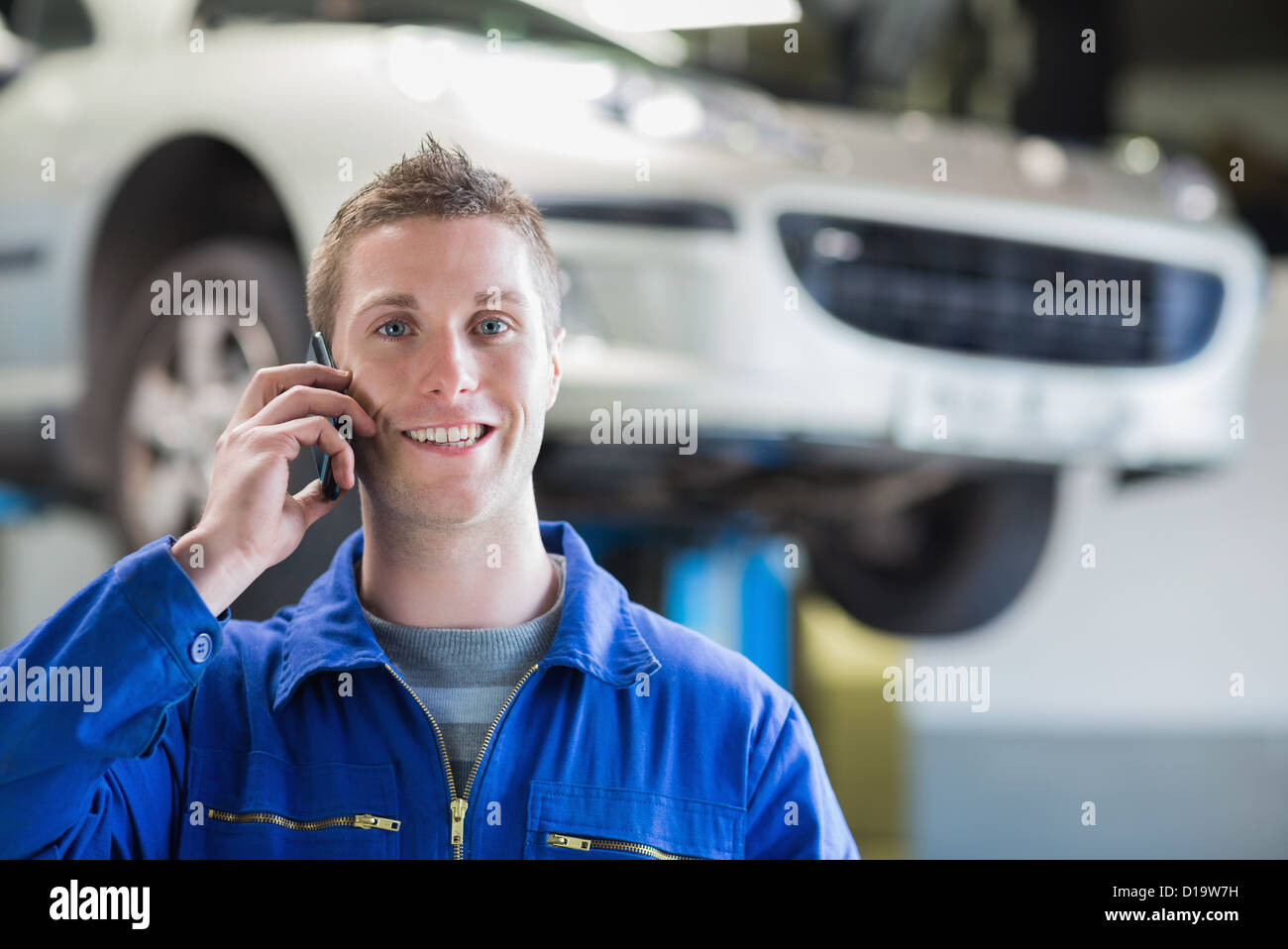 Car mechanic using mobile phone Stock Photo Alamy