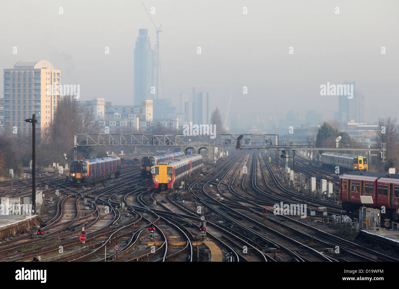 Trains approach and depart from Clapham Junction station in London. Stock Photo