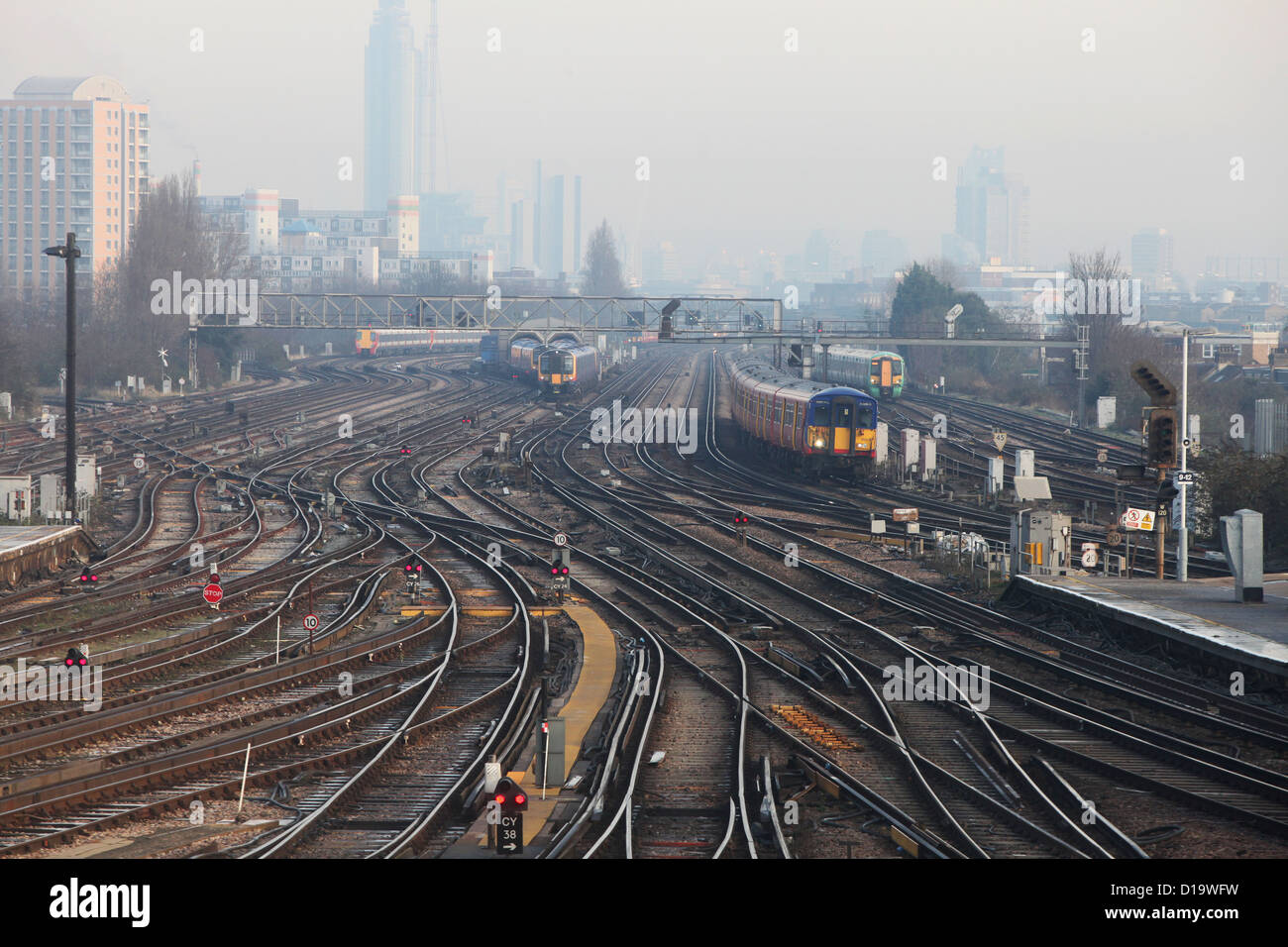 Trains approach and depart from Clapham Junction station in London. Stock Photo
