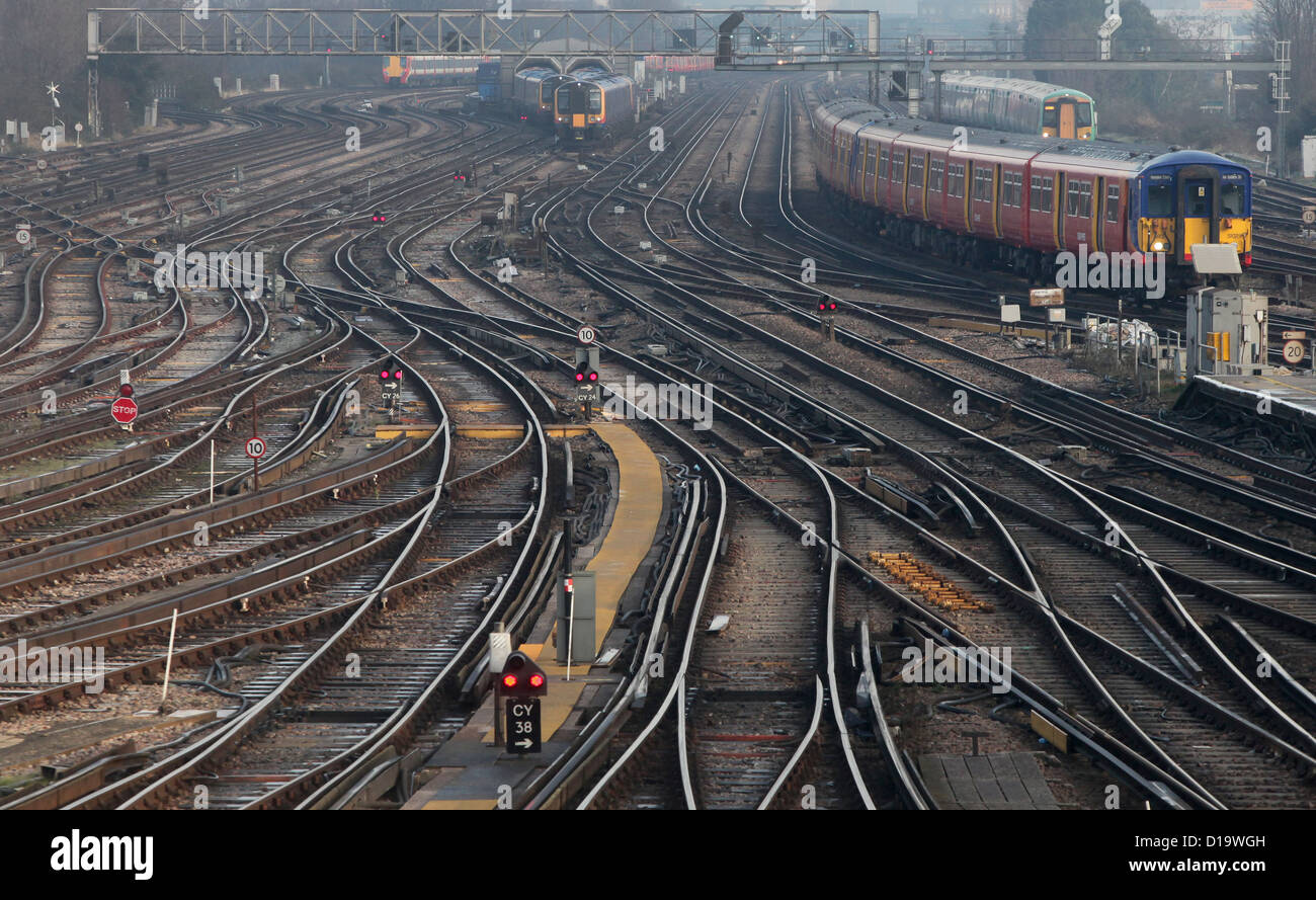 Trains approach and depart from Clapham Junction station in London