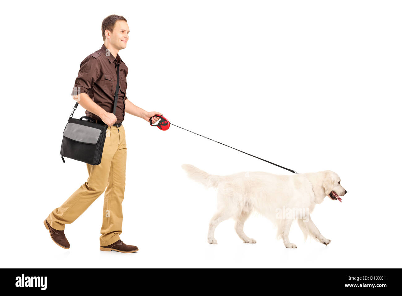 Full length portrait of a guy with shoulder bag walking a dog isolated