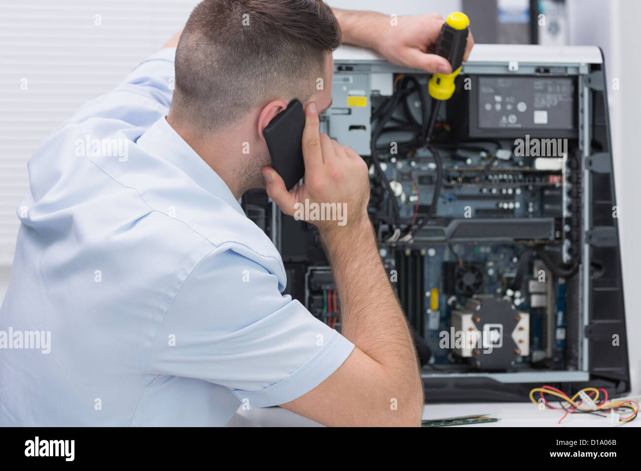 Computer engineer working on cpu while on call Stock Photo Alamy