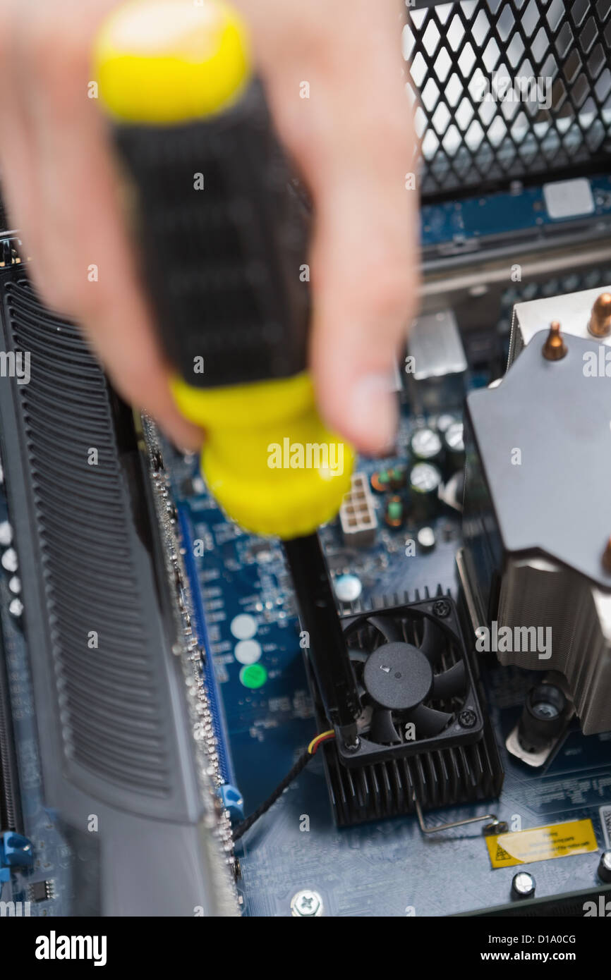 Hand using screw drive to fix processor fan Stock Photo Alamy