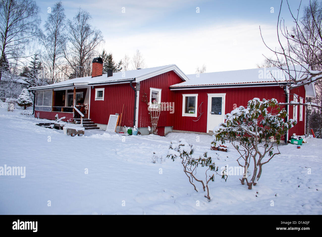 Red cottage in snow in Sweden. Property release available Stock Photo