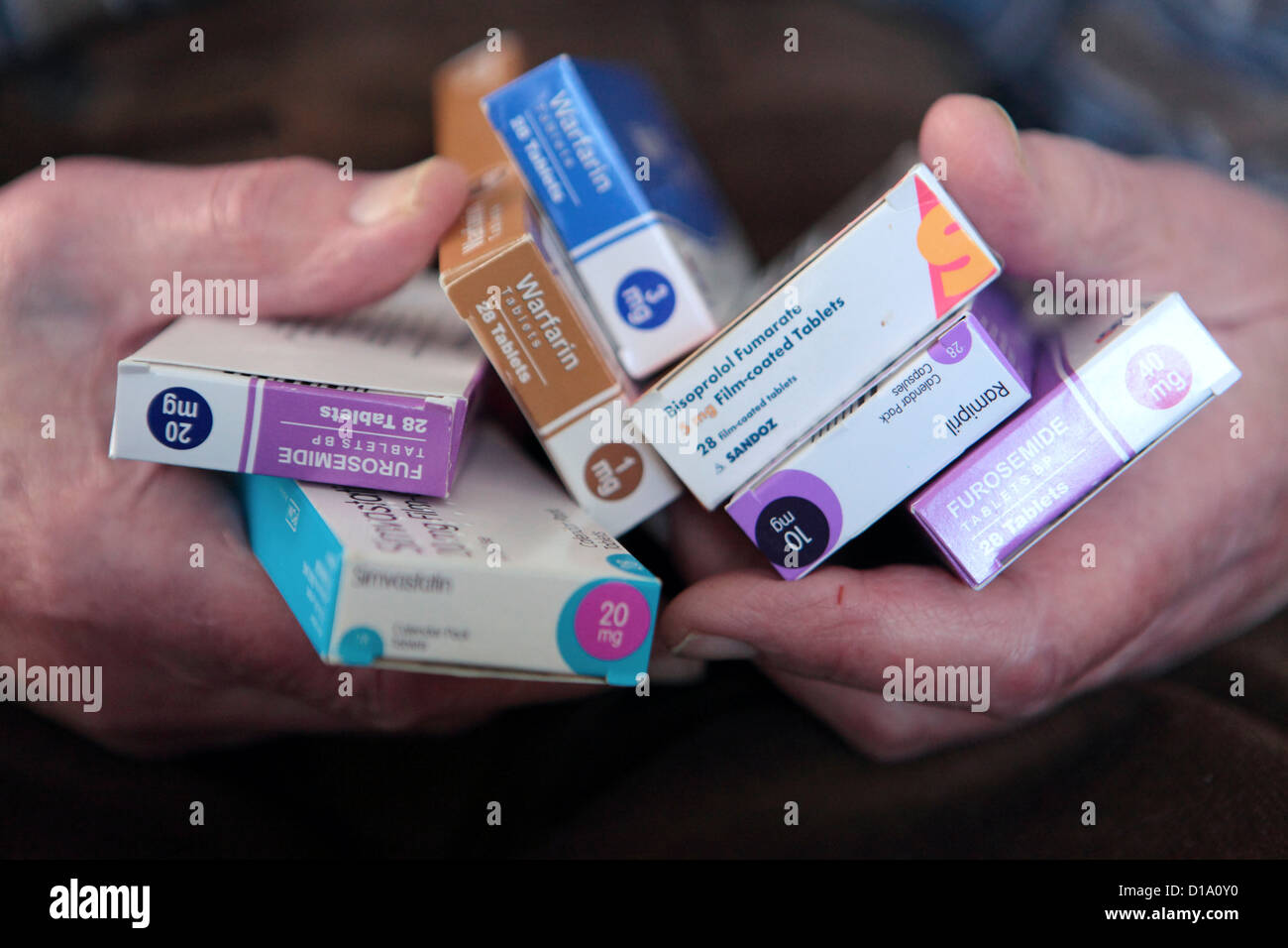 Elderly old aging man's hands holding medication tablets, heart, pain