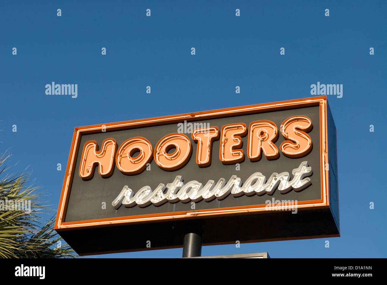 Hooters restaurant sign against blue sky, United States. Stock Photo